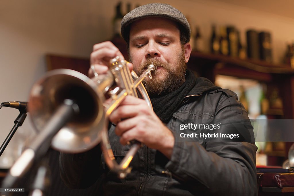 Trumpet player playing into microphone