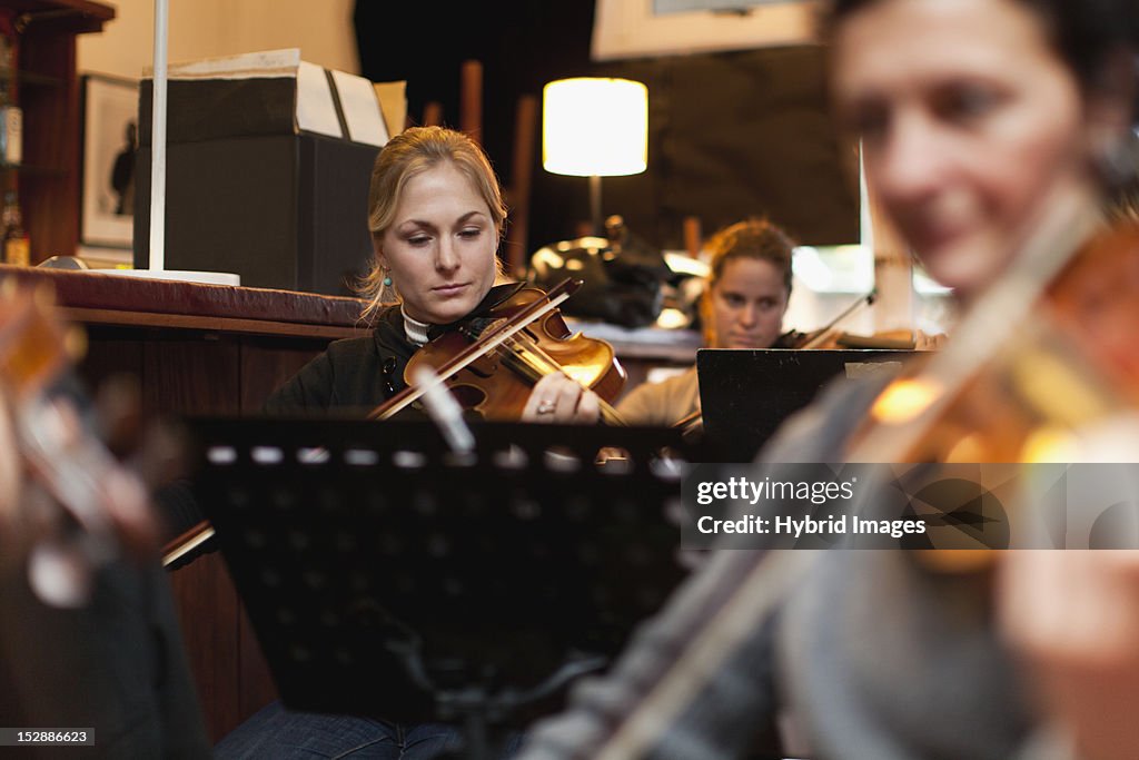 Violin player practicing with group