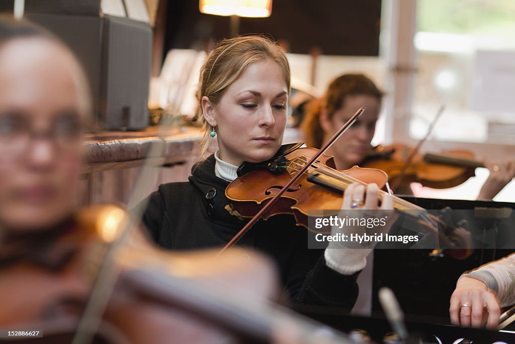 Violin player practicing with group