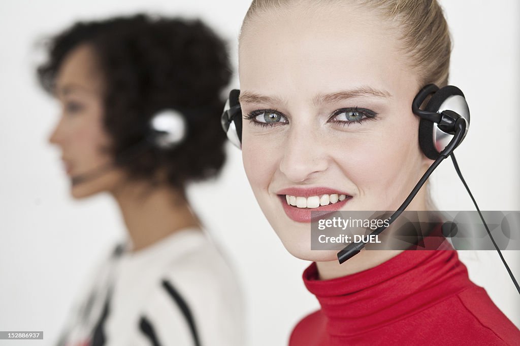 Businesswomen wearing headsets
