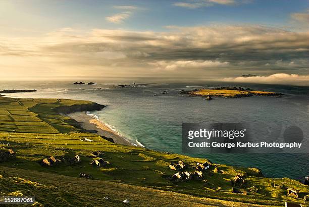 houses on grassy rural hillside - great blasket island stock pictures, royalty-free photos & images