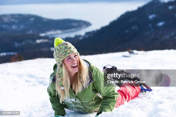 a athletic young woman laughs while snowshoeing in idaho. - leisure equipment stock pictures, royalty-free photos & images