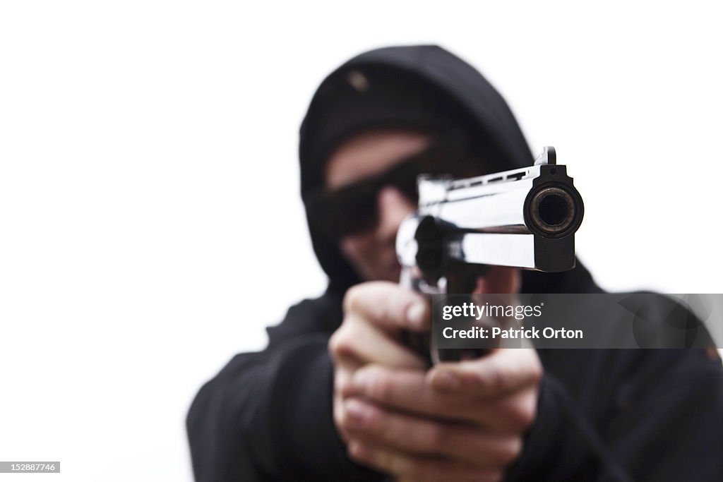 A young man points his large hand gun in Montana.