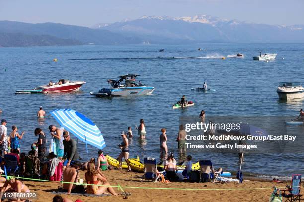 Beachgoers and boaters spend time at Kings Beach in Kings Beach, Calif., on Friday, June 30, 2023. According to research, Lake Tahoe is the clearest...