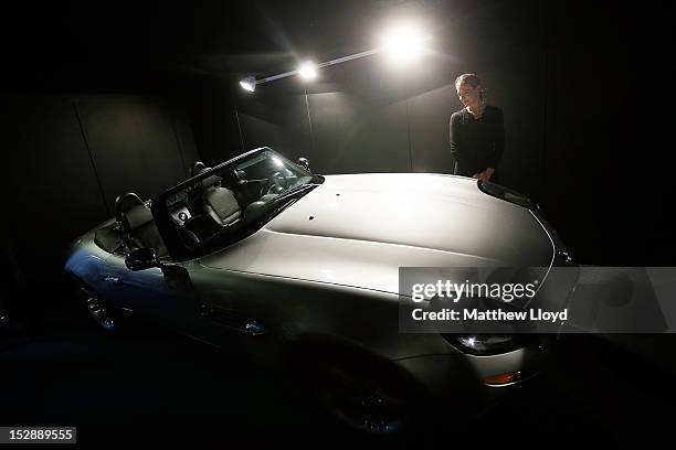 An employee stands by a pre-production replica of a BMW Z8 used by Pierce Brosnan as James Bond in the film "The World is Not Enough", at Christie's...