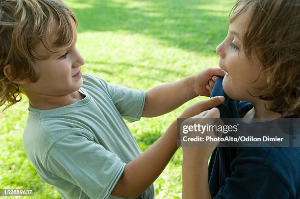 boys fighting, one gripping the other's shirt - tag 7 bildbanksfoton och bilder