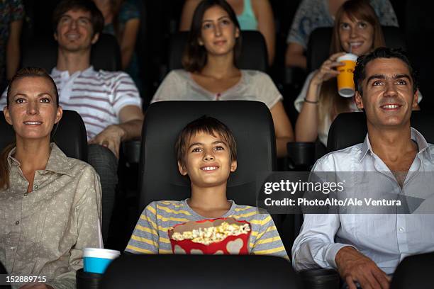 family watching movie in theater - film 2012 fotografías e imágenes de stock