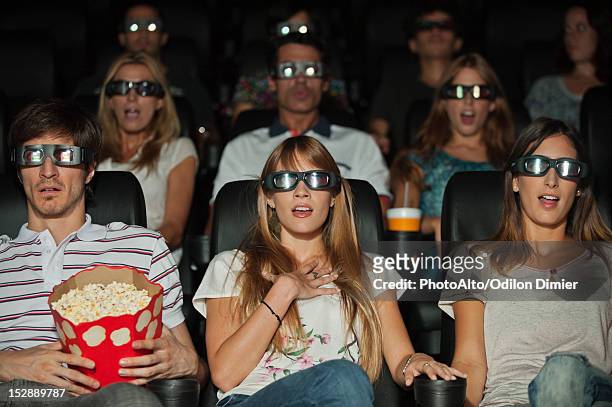 audience wearing 3-d glasses in movie theater - 3d adult movie stockfoto's en -beelden