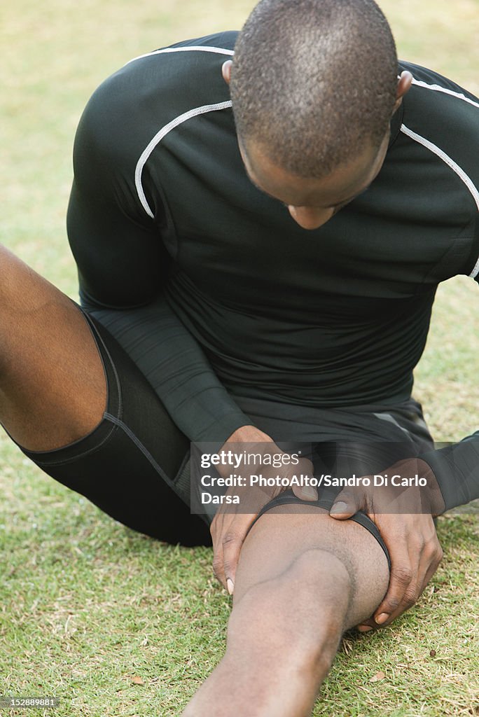 Man with cramp in thigh