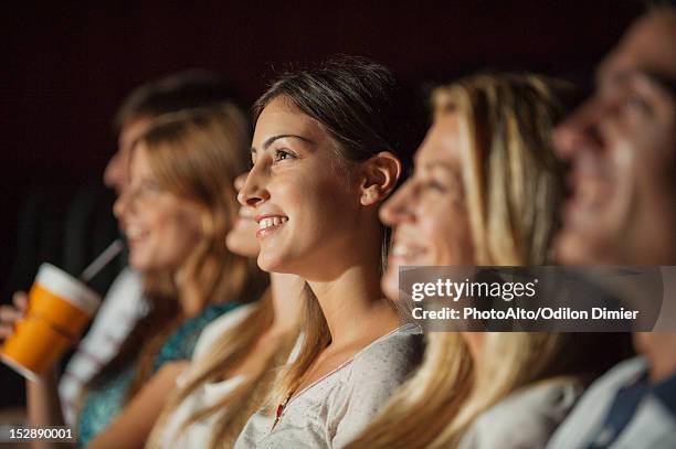 woman watching movie in theater - film 2012 fotografías e imágenes de stock