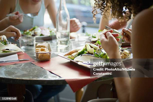 friends enjoying meal in cafe, cropped - restaurant women friends lunch stock pictures, royalty-free photos & images