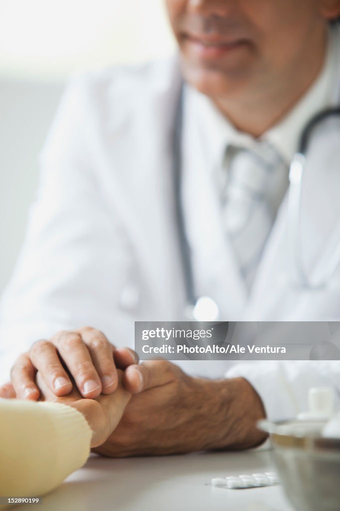 Doctor reassuring patient during consultation, cropped