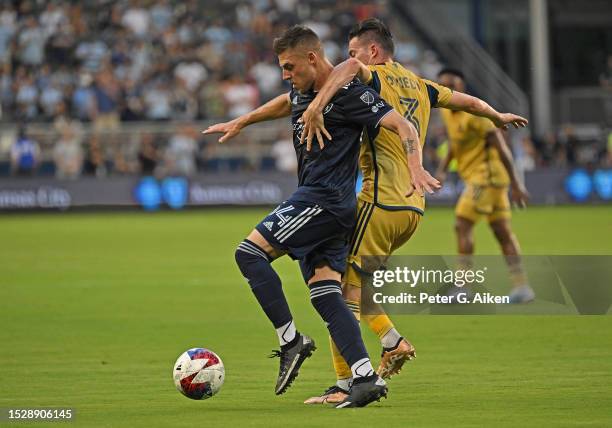 Remi Walter of Sporting Kansas City battles for the ball with Bryan Oviedo of Real Salt Lake in the first half on July 12, 2023 at Children's Mercy...