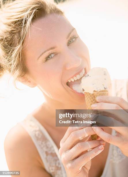 usa, new jersey, jersey city, woman eating ice cream - woman ice cream stock pictures, royalty-free photos & images