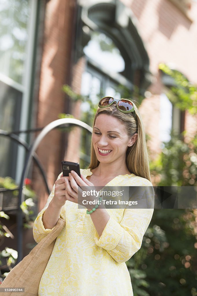 USA, New Jersey, Jersey City, Woman using cell phone