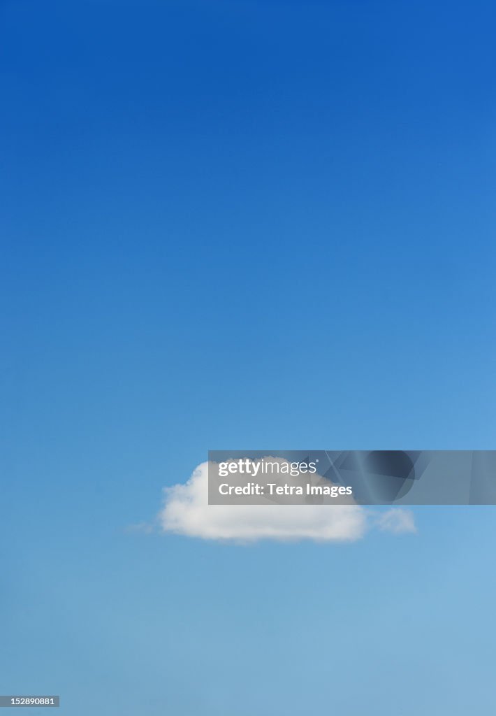 Blue sky with single cloud