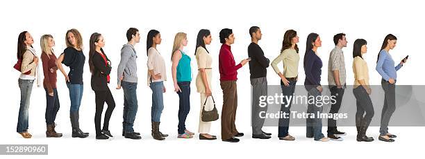 studio shot of people waiting in line - lining stock pictures, royalty-free photos & images