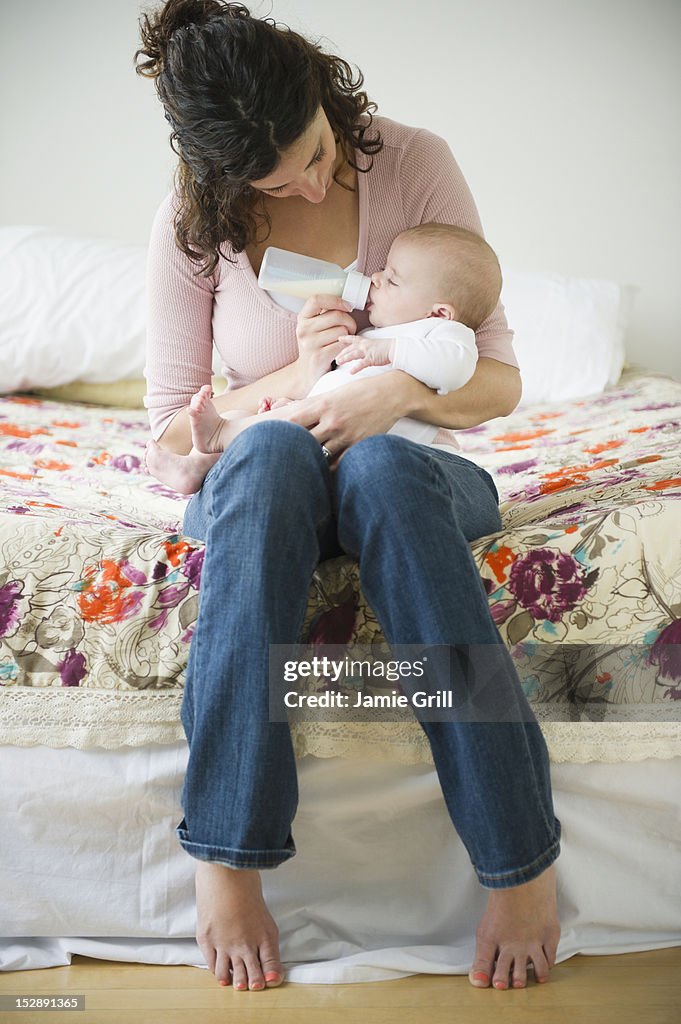 USA, New Jersey, Jersey City, Mother feeding baby boy (2-5 months) using feeding bottle