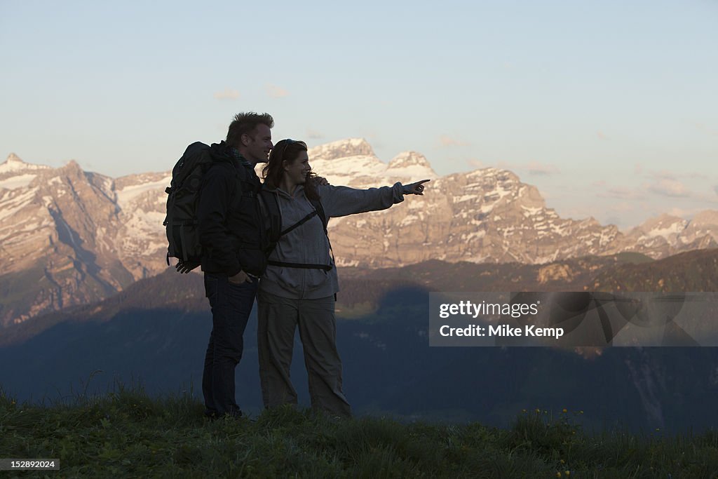 Switzerland, Leysin, Hikers looking at view of Alps