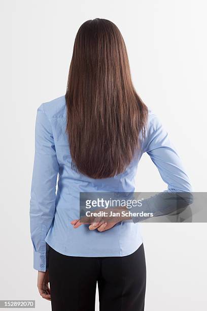 back view of woman with crossed fingers - brunette woman back stockfoto's en -beelden