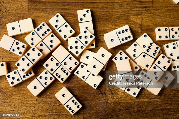 domino tiles on wooden surface, studio shot - dominoes stock pictures, royalty-free photos & images