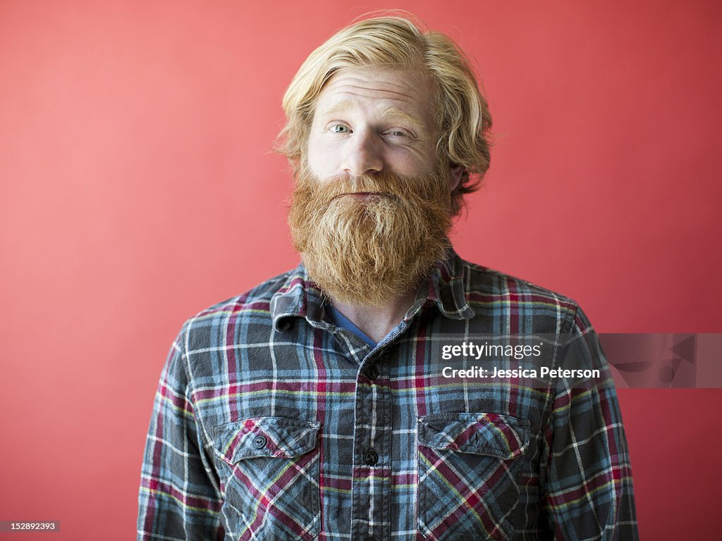 Portrait of smiling man with beard, studio shot