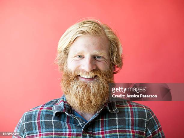 portrait of smiling man with beard, studio shot - beard imagens e fotografias de stock