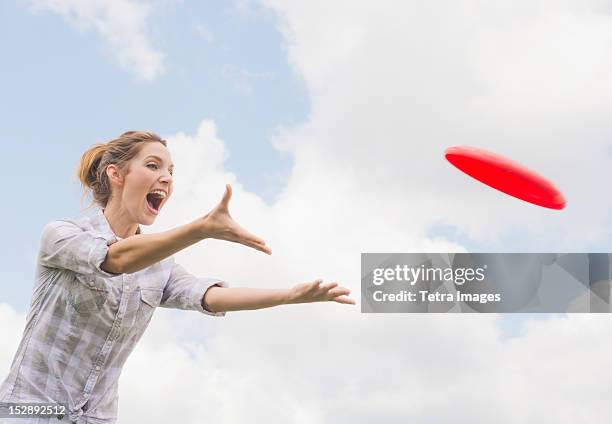 usa, new jersey, mendham, woman playing with frisbee - woman catching stock pictures, royalty-free photos & images