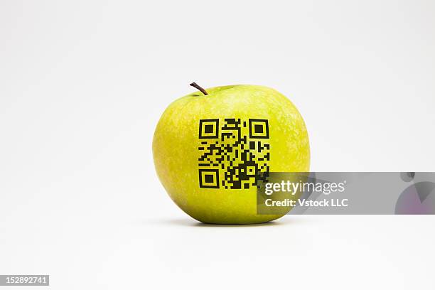 studio shot of apple with bar code on it - food barcode stock pictures, royalty-free photos & images
