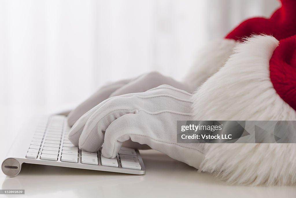 USA, Illinois, Metamora, close-up of Santa Claus typing on computer keyboard