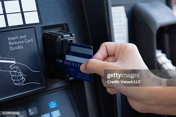 usa, illinois, metamora, close-up of woman paying by credit card - petrol paying ストックフォトと画像