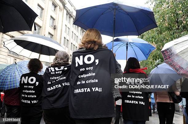 Government employees with t-shirts that read "No, I am not guilty of the crisis, stop" take part in a demonstration against the Spanish government's...