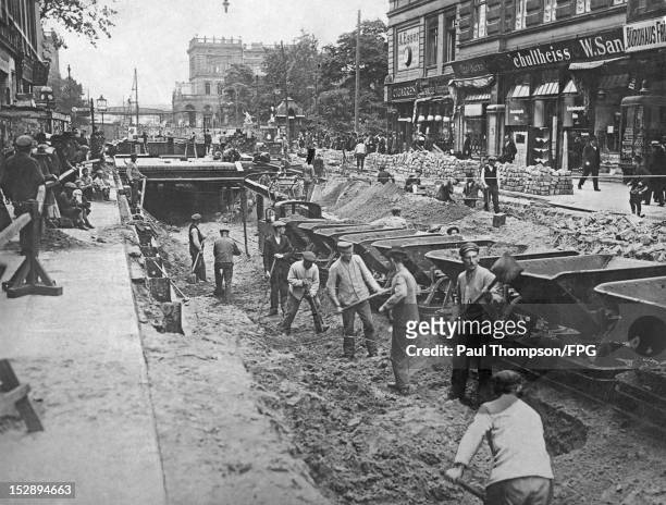 German soldiers use their experience of trench-digging to construct the Berlin subway of U-Bahn, circa 1919. Here they are working in...