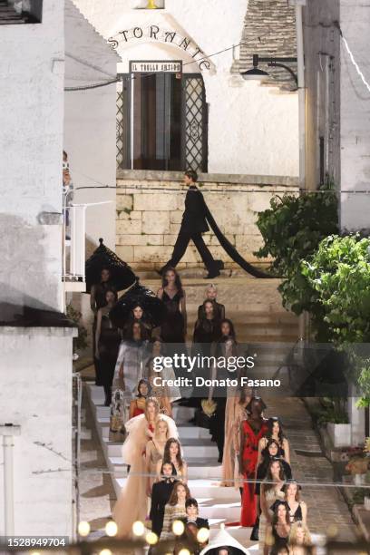 Models walk in the Dolce & Gabbana show on July 09, 2023 in Bari, Italy. Alberobello is transformed into an open-air catwalk for the Dolce & Gabbana...