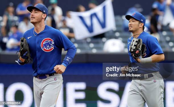 Cody Bellinger and Seiya Suzuki of the Chicago Cubs celebrate after defeating the New York Yankees at Yankee Stadium on July 9, 2023 in the Bronx...