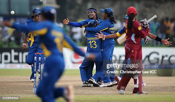 Deepika Rasangika , Eshani Lokusooriya and Shashikala Siriwardena of Sri Lanka celebrate their victory as Anisa Mohammed of West Indies watches...