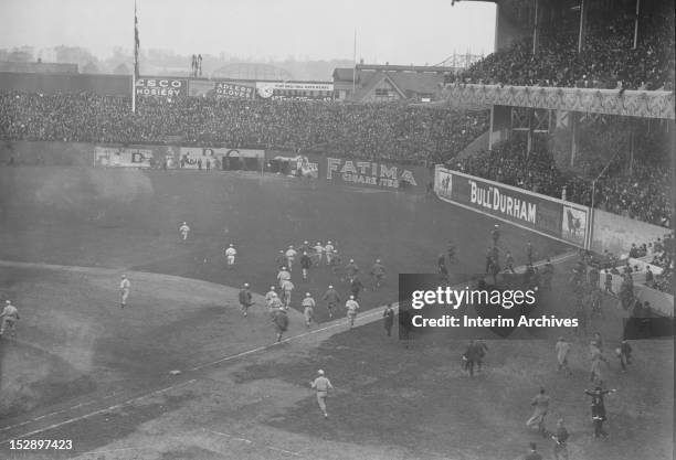 View of the conclusion of game three of the 1913 World Series between the Philadelphia Athletics and the New York Giants, showing baseball players...