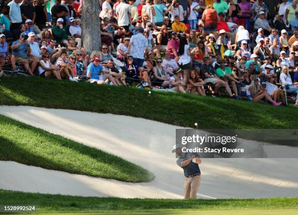 Chris Kirk of the United States plays a shot from a bunker on the 18th hole during the final round of the John Deere Classic at TPC Deere Run on July...