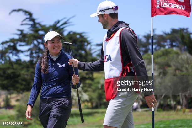Allisen Corpuz of the United States reacts with caddie Jay Monahan after making birdie on the second green during the final round of the 78th U.S....