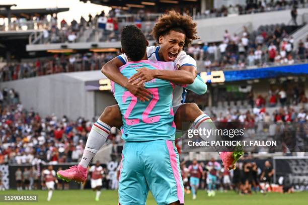 Panama's midfielder Adalberto Carrasquilla celebrates with Panama's goalkeeper Orlando Mosquera after scoring the winning penalty kick during the...