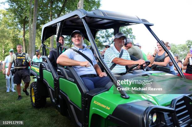 Sepp Straka of Austria is driven to the 18th hole for the trophy ceremony after winning the John Deere Classic at TPC Deere Run on July 09, 2023 in...