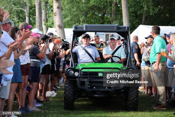 Sepp Straka of Austria is driven to the 18th hole for the trophy ceremony after winning the John Deere Classic at TPC Deere Run on July 09, 2023 in...