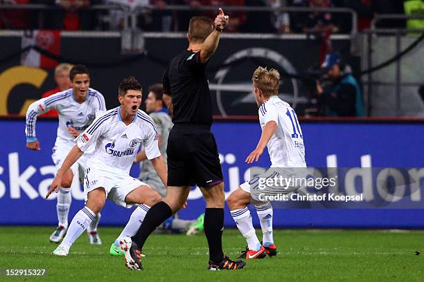 Klaas-Jan Huntelaar of Schalke celebrates the first goal with Ibrahim Affelay and Lewis Holtby of Schalke during the Bundesliga match between Fortuna...