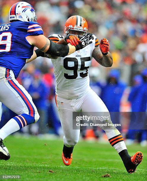 Defensive linemen Juqua Parker of the Cleveland Browns rushes the passer during a game with the Buffalo Bills at Cleveland Browns Stadium in...