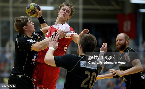 Niclas Pieczkowski of Essen in action against Ferdinand Michalik and Nico Buedel` of Neuhausen during the DKB Handball Bundesliga match between TUSEM...