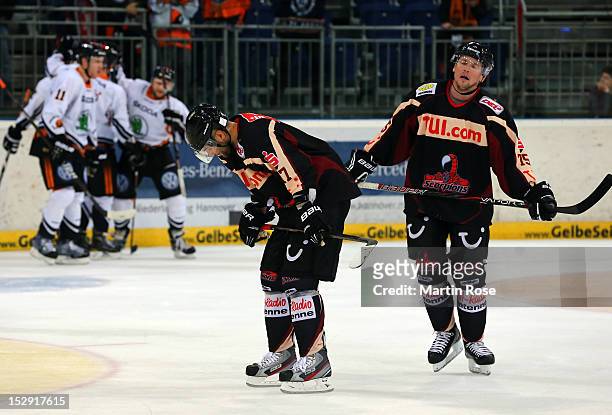 Maris Jass of Hannover and Andreas Morczinietz of Hannover look dejectead during the DEL match between Hannover Scorpions and Grizzly Adams Wolfsburg...
