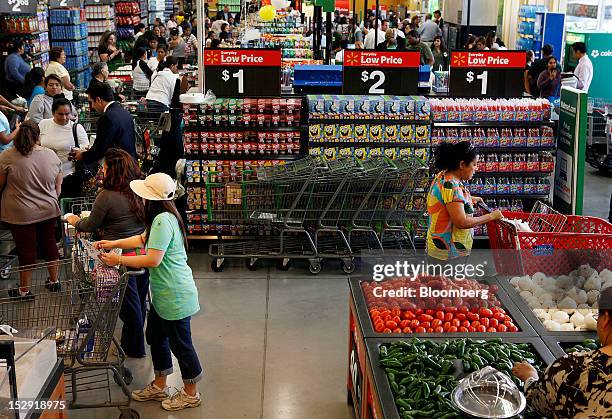 Customers shop during the grand opening of a Wal-Mart Stores Inc. Location in Panorama City, California, U.S., on Friday, Sept. 28, 2012. Wal-Mart...