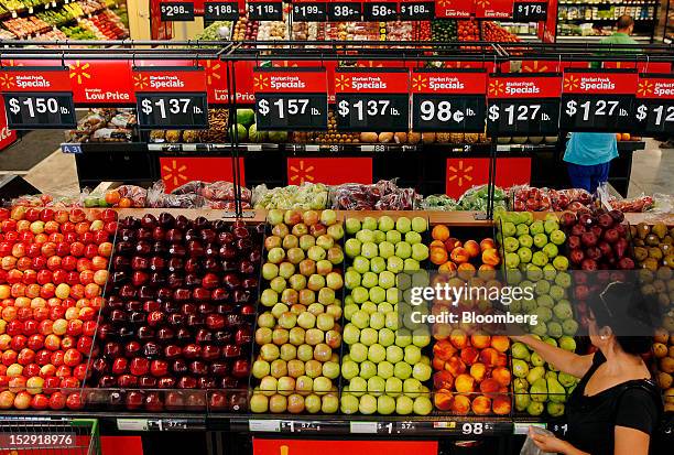Customer shops for produce during the grand opening of a Wal-Mart Stores Inc. Location in Panorama City, California, U.S., on Friday, Sept. 28, 2012....