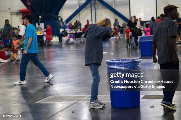 Woman brushes her hair after taking shelter from the Tropical Storm Harvey at the George R. Brown Convention Center in Houston, Monday, Aug. 28, 2017.