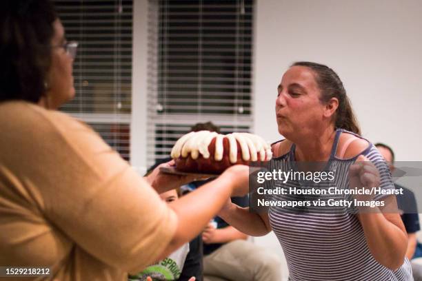 Nicki Thibodeaux blows a candle after her friend Michelle Cox surprised her with a birthday cake in Thibodeaux's new home in Kingwood, Friday, Oct....